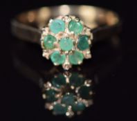 A 9ct gold ring set with emeralds in a cluster, 2.8g, size N