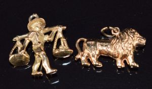 Two 9ct gold charms / pendants, one a lion the other an Eastern farmer with yoke, 3.2g