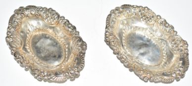 Victorian pair of hallmarked silver bon bon dishes with embossed and pierced decoration, Chester