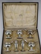 Cased George V hallmarked silver cruet set comprising three open salts and two mustards, all with