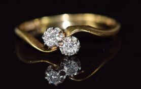 An 18ct gold ring set with two diamonds in a twist setting, 2.2g, size S
