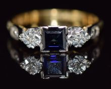 An 18ct gold ring set with a square cut sapphire and diamonds in a platinum setting, 3.7g, size P