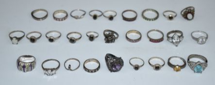 A collection of silver rings including sapphire, ruby, opal, etc