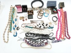 A collection of costume jewellery including bangles, two silver mounted items, beads, abalone