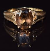 A 9ct gold ring set with an oval cut smoky quartz, 2.7g, size N