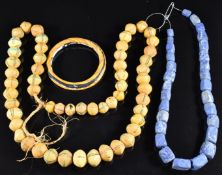 A single strand of lapis lazuli beads, a strand of Venetian yellow glass bicone trade beads and a