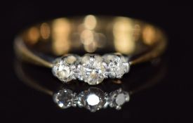 An 18ct gold ring set with three diamonds, 1.6g, size M