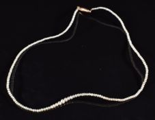 A single strand of seed pearls with 9ct gold barrel clasp, 31cm, 2.2g