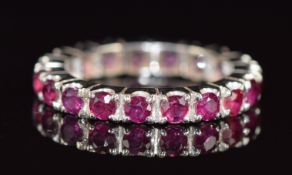 An 18ct white gold eternity ring set with rubies, each approximately 0.1ct, 4.3g, size N