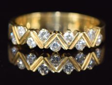 An 18ct gold ring set with diamonds in a zigzag design, 3.9g, size N