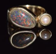 A 9ct gold ring set with a pear shaped black opal cabochon and pearl, 8.7g, size O