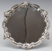 George V hallmarked silver salver with shaped edge, raised on three hoof feet, Sheffield 1928, maker