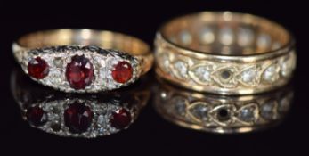A 9ct gold eternity ring and a 9ct gold ring set with garnets, 6.6g, size O & Q
