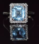 Art Deco platinum ring set with an emerald cut aquamarine of approximately 2.4ct surrounded by