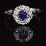 A c1920 18ct white gold ring set with a sapphire surrounded by old cut diamonds, 3g, size M