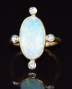 A c1920 18ct gold ring set with an opal cabochon and old cut diamonds, 3.4g, size E/F