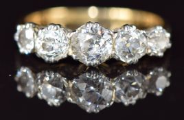 An 18ct gold ring set with five old cut diamonds, the centre diamond approximately 0.45ct, in a