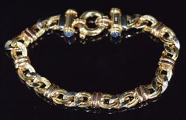 An 18ct gold bracelet made up of single and double oval links set with four sapphire cabochons, 14.