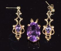 A 9ct gold pendant set with an oval amethyst and a pair of 9ct gold earrings set with an amethyst to