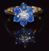A 9ct gold ring set with a round cut diamond surrounded by sapphires, 2.7g, size P