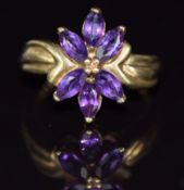 A 9ct gold ring set with marquise cut amethysts, 3.7g, size M