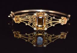 A 9ct gold bangle set with an emerald cut citrine and seed pearls, 7.8g, 4.8 x 5.5cm