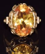 A 9ct gold ring set with an oval cut synthetic yellow sapphire, 5.7g, size N