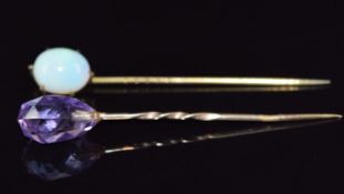 Two Victorian stick pins, one set with a briolette cut amethyst and the other an opal cabochon, 5.