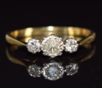 An 18ct gold ring set with three diamonds in platinum setting, 1.9g, size K