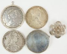 Three Maria Theresia coins, two in mounts, together with a QEII mounted silver crown