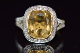 An 18ct gold ring set with a cushion cut quartz and diamonds, 10.1g, size N