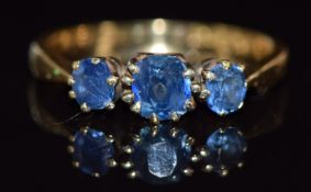 An 18ct gold ring set with three cushion cut sapphires, Birmingham 1922, 3g, size O