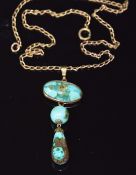 A c1920 yellow metal pendant set with a turquoise cabochon, round bead and pear drop on 9ct gold