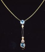 A c1915 9ct gold necklace set with a round cut and oval cut aquamarine, two seed pearls and rose cut