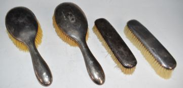 Two pair of hallmarked silver backed brushes, all Birmingham 1907