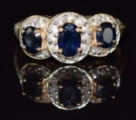 A 14k gold ring set with three sapphires and diamonds, 2.9g, size N/O