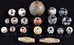 A collection of 19thC Venetian glass beads including eye beads, chequered and millefiori, largest