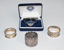 Three hallmarked silver napkin rings including a millennium feature hallmarked example, weight 35g