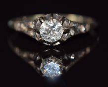 A c1930 platinum ring set with a diamond of approximately 0.3ct with diamond encrusted shoulders,