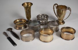 Seven various hallmarked silver napkin rings, small twin handled trophy cup, Birmingham 1933,