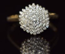 A 9ct gold ring set with diamonds in a cluster, 3.3g, size O