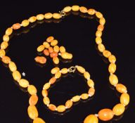 A strand of thirty nine Baltic amber oval beads with matching bracelet of fifteen beads, largest