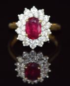 An 18ct gold ring set with an oval cut ruby of approximately 1.1ct surrounded by two rows of