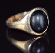 A 9ct gold signet ring set with an onyx cabochon, 4.9g, size S/T