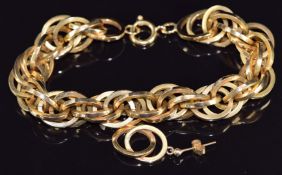 An 18ct gold bracelet made up of oval links with spare link/ earring, 27.6g, 18cm long
