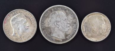 1876 5 reichsmark together with a 1910 3 reichsmark and a 1936 5 reichsmark coin