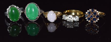 A white metal ring set with a jadeite cabochon, a Chinese silver ring set with lavender jade and