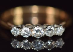 An 18ct gold ring set with five diamonds, 2.4g, size M