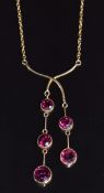 Edwardian 9ct gold necklace set with five round cut garnets, in vintage box, pendant drop 5cm, on 43