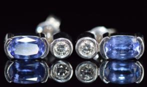 A pair 18ct white gold earrings set with an oval cut tanzanite and diamonds, 3.4g, 1.3cm